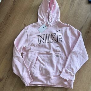 New with tags Nike pink hoodie with black lettering. Mens size large.
